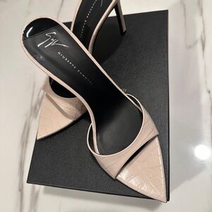 Pointed open-toe mule sandals in crocodile-print leather with stiletto heel.